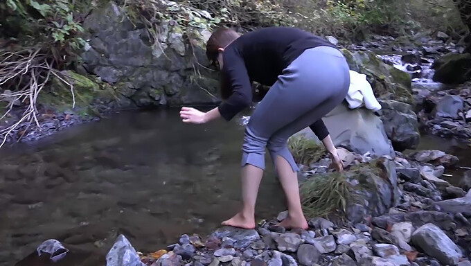 College Student Experiences Trembling In The Cold During Winter River Adventure